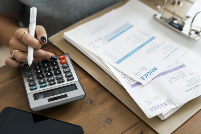 Bookkeeping workspace with pen and calculator